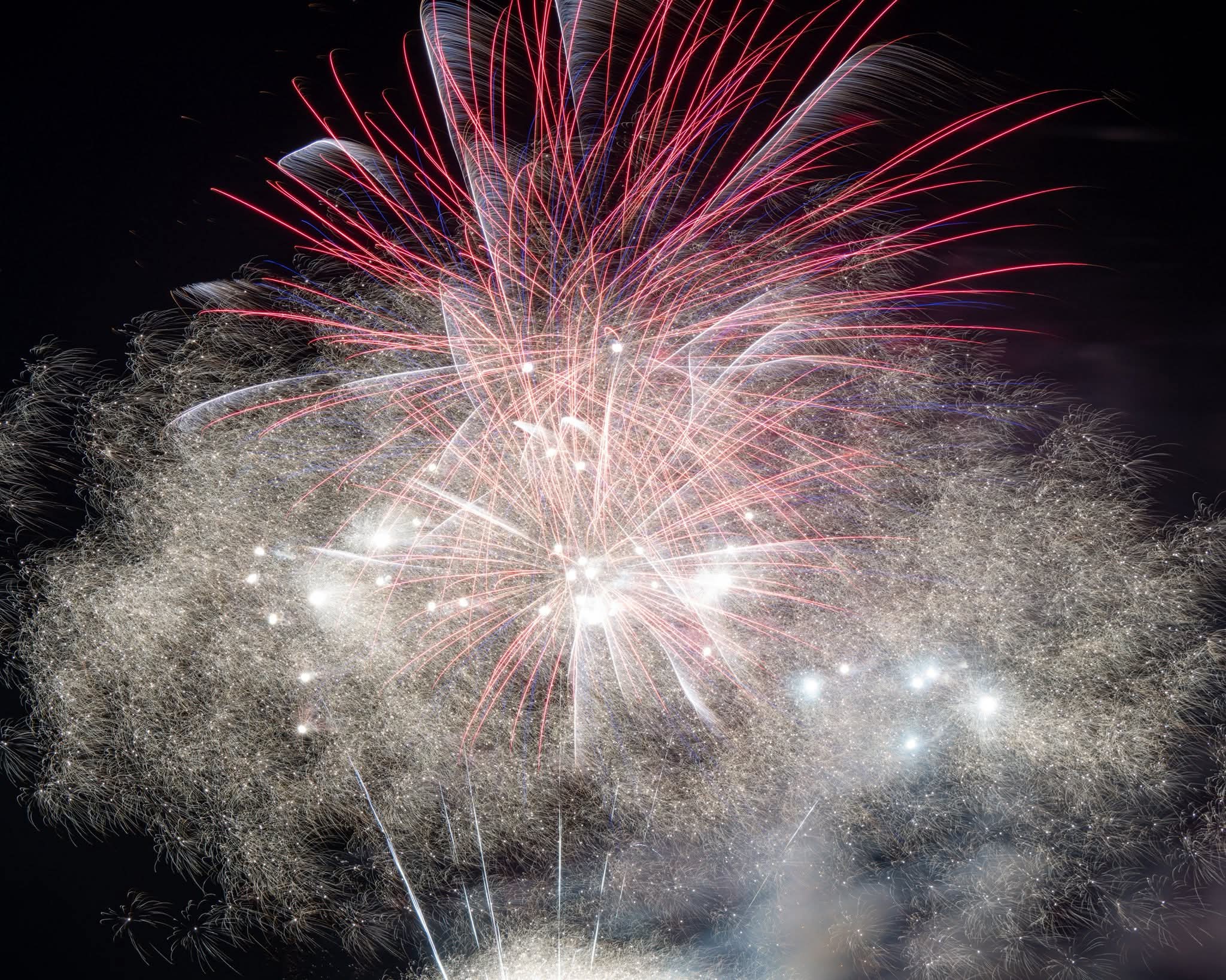 Fireworks reflected in water during a holiday celebration